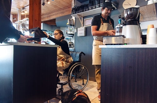 Shop worker in wheelchair iStock lise gagne