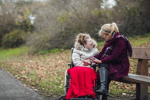 Carer and daughter young girl disabled